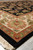 Angled corner view of the rectangular wool rug, ivory border meeting black floral field