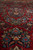 Low angle across red pile revealing salmon, gold and midnight blue flower clusters