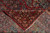 Folded back revealing tight hand-knotted weave, cotton foundation and clear design on the reverse