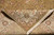 Folded corner revealing tight hand-knotted back, ivory fringe and dense wool and silk pile