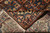 Folded corner revealing dense hand-knotted wool pile and the tight weave on the reverse