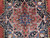 Close-up of the 8 point star medallion with blue burst, rose and sage floral detail