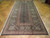 6'5" x 12'10" Persian Tabriz rug laid on parquet floor in a long gallery format