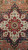 Close-up of the ivory and red stepped star medallion with sage green rosette center