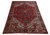 9'2" x 12' Persian Heriz rug photographed at an angle showing full geometric field and border