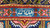 Woven signature cartouche in the sky blue border panel of this signed Tabriz rug
