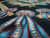 Angled floor view showing thick wool pile, diamond ribbon motifs and rich blue shading