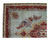Corner detail showing ivory guard stripes, red main border and flowering sprays on turquoise ground