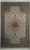 Whole rug seen flat: ivory floral field, rose-brown medallion and green border with ivory fringe