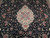 Close-up of ivory central medallion surrounded by rose, slate blue and green floral vinework