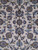 Close up of navy and sky blue palmettes and rosettes on ivory Kashan field