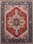 Full view of 8'10" x 12'1" Serapi rug with rustic red field and navy border