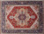 Rustic red field and ivory spandrels framing the camel and navy stepped geometric medallion