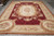 Full floor view of flat weave Aubusson rug showing wine field and ivory floral border