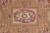 Detail of sage green field, fruit filled panels and pink rose medallion on this Aubusson design