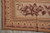 Corner detail of the brown rose border with leaf tipped guard stripe on ivory ground