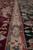 Camel guard border with cartouche meeting the dark green main border and burgundy field