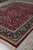 9'3" x 12'3" Chinese Tabriz design rug viewed lengthwise on grey tile showroom floor