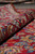 Rolled edge of the 9'6" x 14'10" Persian rug showing border drawing and soft wool pile