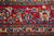 Main border close-up with red ground, pink rosettes, blue leaves and gold tendrils