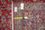 Back of the 1980s Persian rug with tape measure, inventory tag and knot density visible