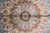 Center rosette close-up with pink petals, blue palmettes and red lattice in bamboo silk pile