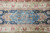 Border close-up showing turquoise cartouche, navy ground florals and ivory vine guard bands