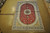 6x9 Chinese silk rug laid flat on showroom floor showing complete Tabriz medallion design