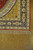 Corner detail showing gold spandrel, navy main border, pale green palmettes and hand-tied ivory fringe