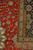 Ruler on the folded back showing fine knots per square inch of this silk rug