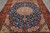 Close overhead of royal blue floral field, rose spandrels and ivory medallion on wool silk pile