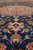 Low angle detail of silk highlighted flowers glowing against the deep blue Isfahan field