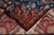 Folded corner revealing red border, beige guard stripe and short wool and silk pile
