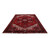 9'8 x 12'10 Heriz rug angled on white studio floor showing ivory fringe and wool pile