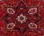 Central ivory star medallion detail with anchor palmettes and olive accents on deep red field