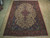 7'2" x 11' Tabriz rug laid on light hardwood floor showing full ivory floral field