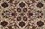 Close-up of navy Shah Abbas palmettes and sky blue rosettes on cream ground, fine curved drawing