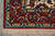 Corner detail with layered navy, gold and ivory guard borders and untouched hand-tied silk fringe