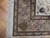 Corner detail showing ivory fringe, tan guard borders and pink and navy palmettes on wool pile