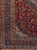 Corner detail of the indigo main border, light blue guard bands and red floral field