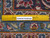 Ruler laid across the back showing fine knots per square inch on this handmade Kashan rug