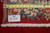 Back of the 10' x 16'4" Kerman rug with tape measure showing tight hand-knotted weave