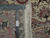 Back of the 6'1" x 9'4" rug with ruler showing tight knot count and authenticity tag
