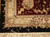 Corner detail showing burgundy main border, taupe guard stripe, black outer band and ivory fringe