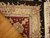 9 x 12 Oriental rug corner folded over hardwood showing tight weave and ivory fringe
