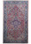 Red Persian Heriz rug with indigo medallion, ivory spandrels and deep navy floral border, full view