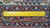 Back of the rug measured with a ruler, showing tight knot density and cotton foundation