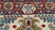 Woven signature cartouche in the rose border of this authentic Persian Tabriz wool rug