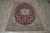 5'6" x 7'10" Nain rug displayed on grey tile showing burgundy field and ivory borders