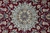 Macro of the layered light blue medallion with brown, navy and ivory petal rosettes